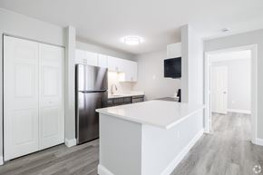 Canton apartment for rent - A modern kitchen with white cabinets and a stainless steel refrigerator.