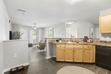 Owings Mills apartment for rent - A kitchen with wooden cabinets and a black dishwasher.