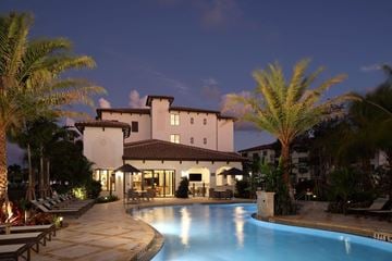 West Palm Beach apartment for rent - A large house with a pool in front of it.
