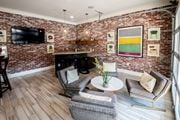 Arden apartment for rent - A living room with a brick wall and a fireplace.