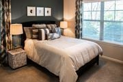 Arden apartment for rent - A bedroom with a large bed and two lamps.