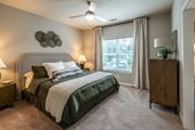 Evans apartment for rent - A bedroom with a large bed and a ceiling fan at Ansley at Town Center Apartments, Evans, GA 30809
