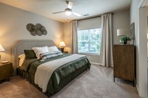 Evans apartment for rent - A bedroom with a large bed and a ceiling fan at Ansley at Town Center Apartments, Evans, GA 30809