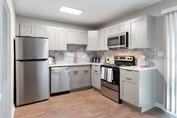 Smyrna apartment for rent - A modern kitchen with a stainless steel refrigerator and wooden flooring.