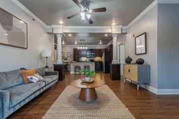 Little Rock apartment for rent - A living room with a grey couch and a wooden coffee table.