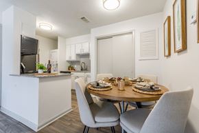 Little Rock apartment for rent - A modern kitchen with a dining table set for two. at Brightwaters Apartments, Little Rock, AR, 72202