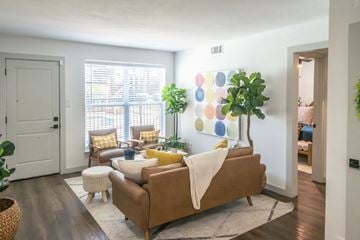 Memphis apartment for rent - A living room with a brown couch and a white blanket on it.