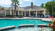 Hardeeville apartment for rent - A pool with a house in the background.