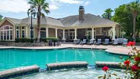 Hardeeville apartment for rent - A pool with a house in the background.