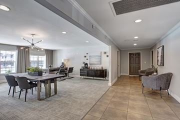 Atlanta apartment for rent - A spacious living room with a dining table and grey sofa.