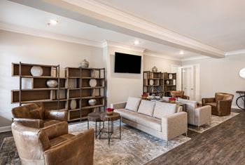 A living room with couches and chairs and a tv