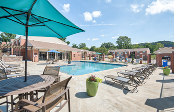 Our apartments offer a swimming pool with tables and chairs