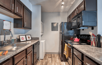 A kitchen with stainless steel appliances and granite counter tops