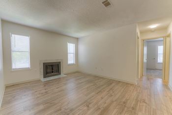 Living room with a fireplace and wooden floors