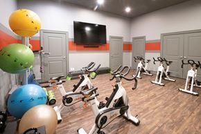 Overland Park apartment for rent - A gym with exercise equipment and exercise balls. at Cambridge Square, Overland Park, KS