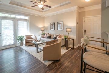 Overland Park apartment for rent - A living room with a brown sofa and a wooden floor.