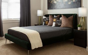 A bedroom with a bed and pillows