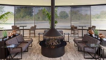 A living room with a fireplace in the middle