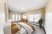 Memphis apartment for rent - A bedroom with a large bed and a window overlooking a balcony.
