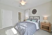 Savannah apartment for rent - a bedroom with a bed and a door to a bathroom at Legends at Chatham Apartments, Savannah