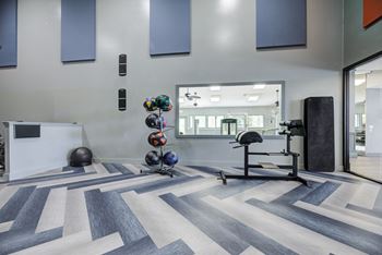 Large state-of-the-art fitness center with fit studio featuring wellbeats system and trx