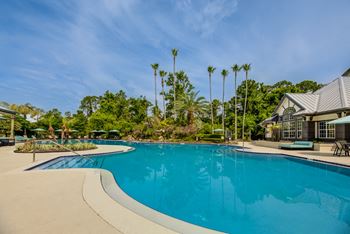 Super pool with waterfall cascading over rock grotto plus wading pool