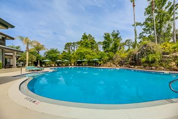 Super pool with waterfall cascading over rock grotto plus wading pool
