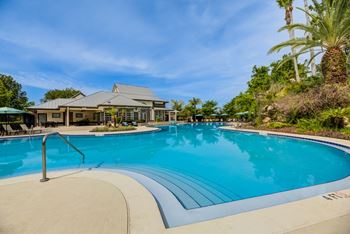 Super pool with waterfall cascading over rock grotto plus wading pool