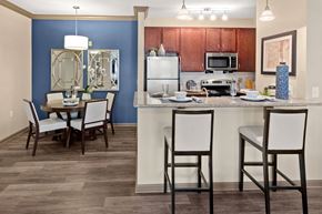 Little Rock apartment for rent - Kitchen with a bar and a dining room table at The Ridge at Chenal Valley Apartments, Little Rock