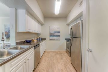 Germantown apartment for rent - A kitchen with white cabinets and a wooden floor.