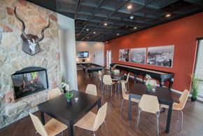 Maumelle apartment for rent - a dining room with tables and chairs and a fireplace at The Villa at River Pointe, Maumelle, AR 72213