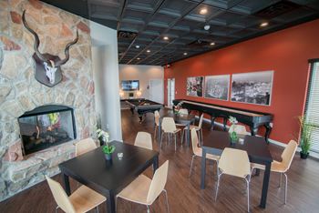 A dining room with tables and chairs and a fireplace