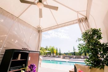 A living room with a pool and a ceiling fan