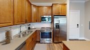 Germantown apartment for rent - A kitchen with wooden cabinets and stainless steel appliances.