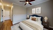 Germantown apartment for rent - A bedroom with a large bed and a ceiling fan.