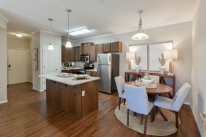 Arlington apartment for rent - A kitchen with a dining table and chairs. at Hall Creek Apartment Homes, Tennessee, 38002