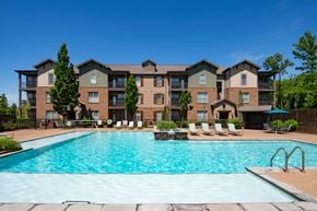 Arlington apartment for rent - A large apartment complex with a swimming pool in front. at Hall Creek Apartment Homes, Tennessee, 38002