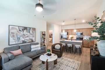 Cordova apartment for rent - A living room with a grey couch and a coffee table.