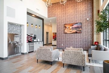 Memphis apartment for rent - A modern living room with a grey sofa and a television on the wall.