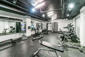 Memphis apartment for rent - A gym with a variety of equipment including treadmills, weights, and exercise machines.at Iris Luxury Apartments, Memphis, TN