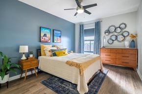 Memphis apartment for rent - A bedroom with a bed, nightstand, and a ceiling fan.at Iris Luxury Apartments, Tennessee, 38105