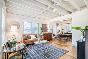 Memphis apartment for rent - a living room with mid century modern brown and blue accents at Kiwi Goji Apartments, Tennessee