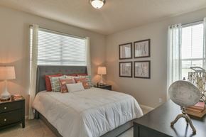 Collierville apartment for rent - a bedroom with a bed and a dresser and a window at Legacy Farm, Tennessee, 38017