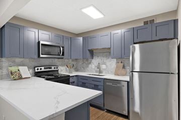 Marietta apartment for rent - A kitchen with a white counter top and stainless steel appliances.