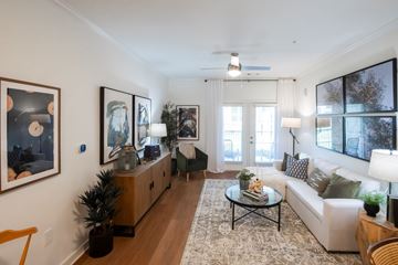 Millington apartment for rent - A living room with a white couch, a coffee table, and a painting on the wall.