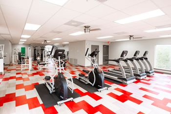 A gym with a red and white checkered floor.