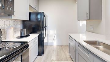 Overland Park townhouse for rent - A modern kitchen with a black refrigerator and stove.