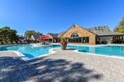 Overland Park townhouse for rent - Revitalizing Resort Style Swimming Pool with Relaxation Space and Seating Area at Pointe Royal Townhome Apartments, Overland Park, KS 66213