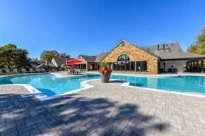 Overland Park townhouse for rent - Revitalizing Resort Style Swimming Pool with Relaxation Space and Seating Area at Pointe Royal Townhome Apartments, Overland Park, KS 66213