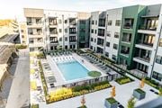 Memphis apartment for rent - A swimming pool is surrounded by apartment buildings at Harbor Side at Conwood Flats Apartments, Memphis, TN, 38107